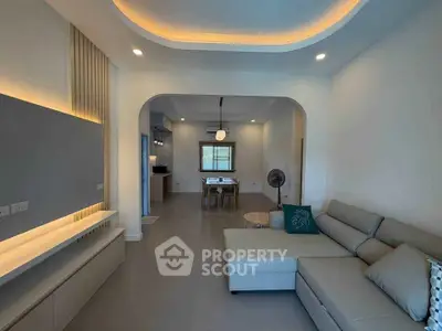 Modern living room with stylish lighting and cozy seating area in a contemporary home.
