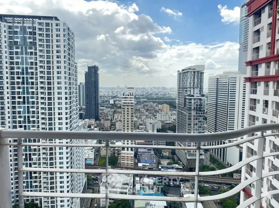 Stunning cityscape view from a high-rise balcony in a modern urban setting.