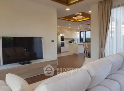 Luxurious open-plan living room with modern kitchen and elegant lighting