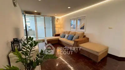 Spacious living room with modern decor and large sofa, perfect for relaxation.