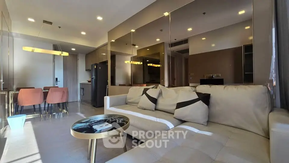 Luxurious modern living room with elegant decor and open kitchen layout, perfect for stylish urban living.