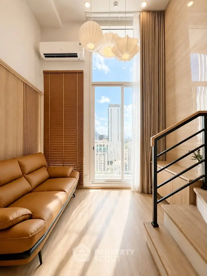 Modern living room with stylish sofa and large window offering city view