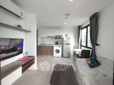Modern living room with open kitchen and washing machine in stylish apartment