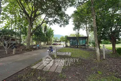 Charming rural property with lush greenery and modern glass cabin, perfect for nature lovers seeking tranquility.