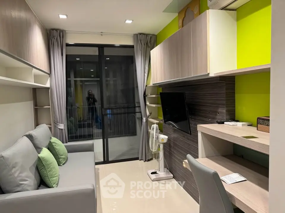Modern living room with sleek design, featuring a cozy sofa, wall-mounted TV, and stylish shelving.