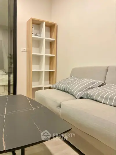 Modern living room with stylish sofa and sleek coffee table in a cozy apartment.