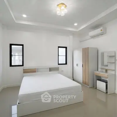 Modern minimalist bedroom with sleek furniture and natural light