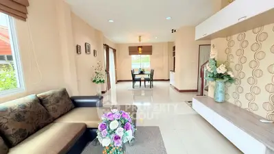 Spacious living room with modern decor and elegant dining area