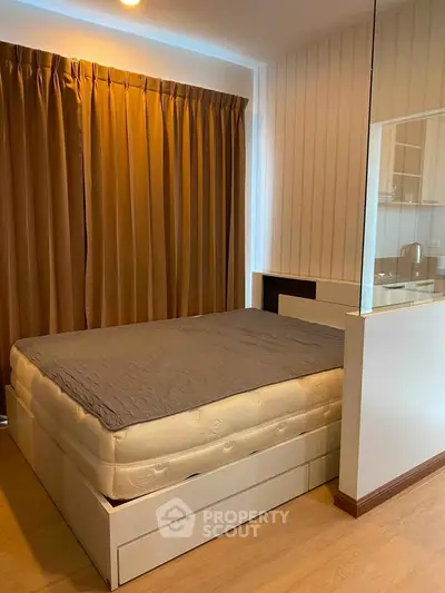 Cozy bedroom with modern design and warm lighting, featuring a comfortable bed and stylish curtains.
