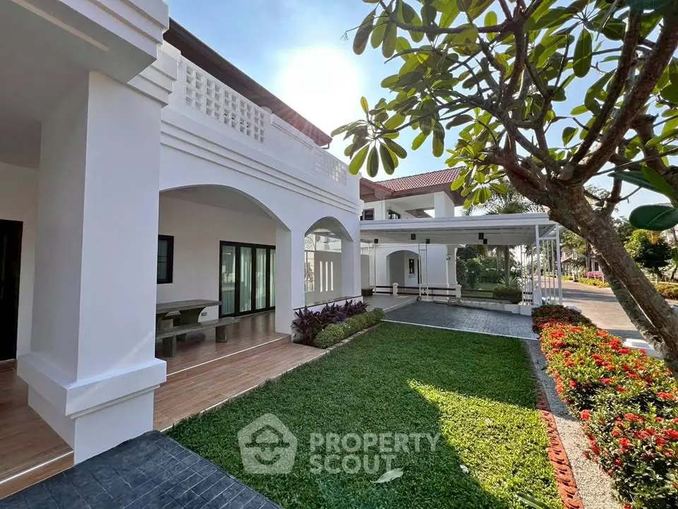 Stunning modern villa with lush garden and spacious patio, perfect for luxurious outdoor living.