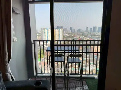 Chic urban balcony with stunning cityscape view, perfect for relaxation and entertainment.