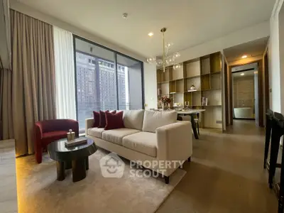 Elegant living room with modern decor and city view, featuring cozy seating and stylish lighting.