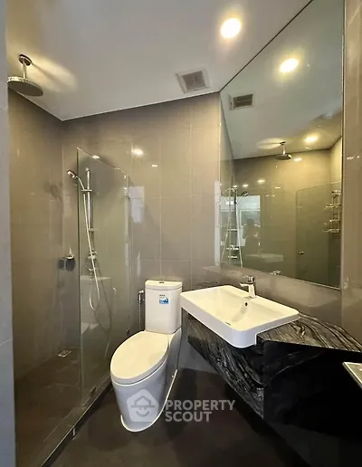 Modern bathroom with sleek fixtures and glass shower enclosure