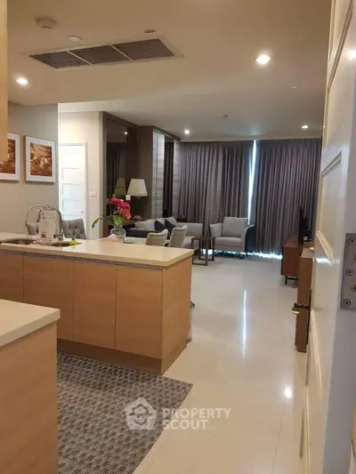 Spacious open-layout living room with modern kitchen and elegant decor
