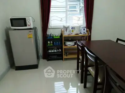 Cozy dining area with modern appliances and elegant dining set