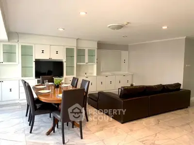 Spacious living room with elegant dining area and modern furniture in a luxurious apartment.