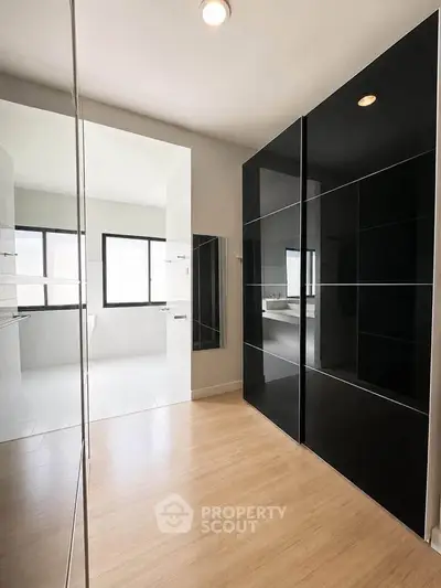 Modern bathroom with sleek black cabinets and natural light