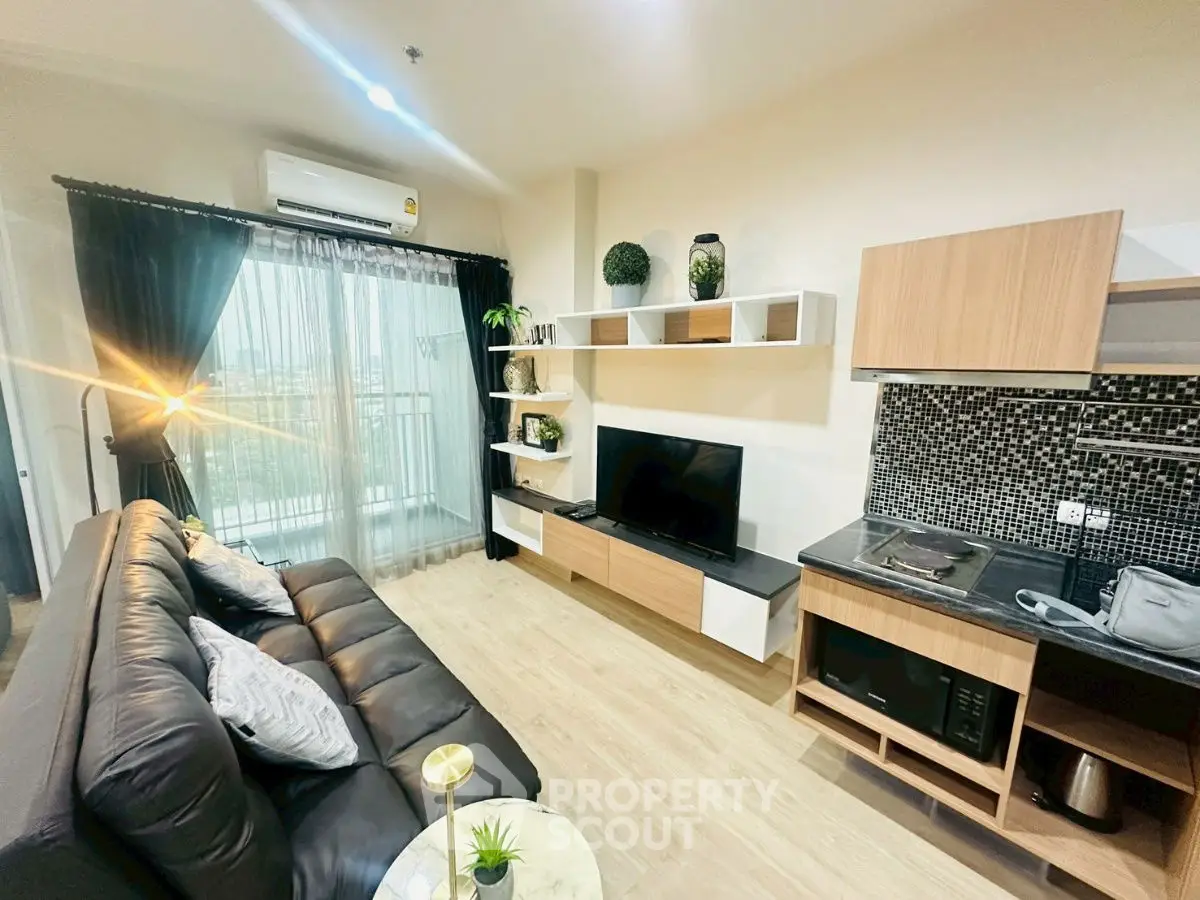 Modern living room with sleek furniture and balcony view