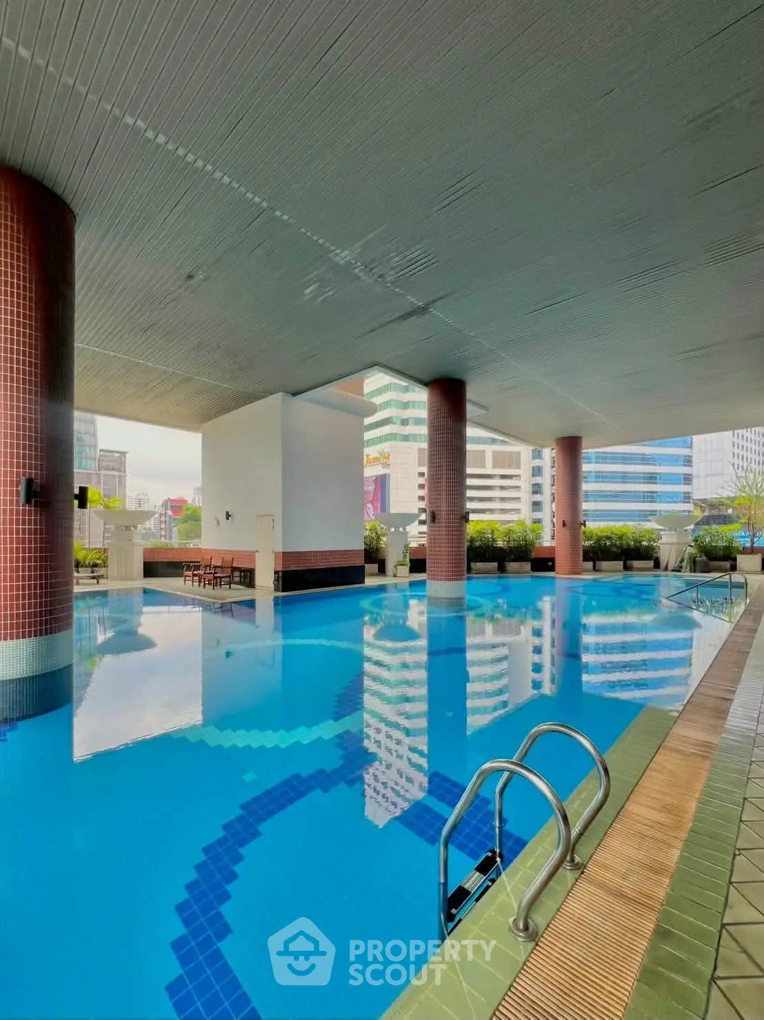 Luxurious rooftop pool with city views in a modern high-rise building, perfect for relaxation and leisure.
