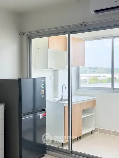 Modern kitchen with open layout and large window offering scenic views.