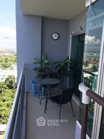 Charming balcony with seating and lush views, perfect for relaxation and enjoying the outdoors.