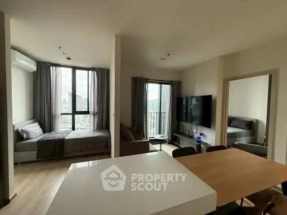 Modern apartment with open living area and city view balcony, perfect for urban living.