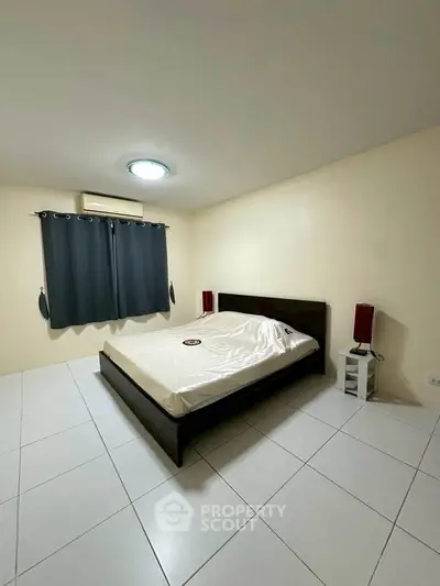 Spacious bedroom with minimalist decor and modern lighting
