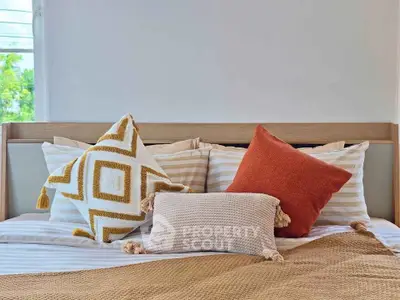 Cozy bedroom with stylish pillows and warm color palette