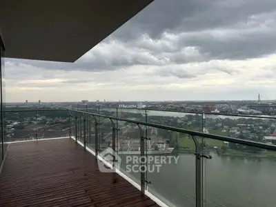Stunning high-rise balcony with panoramic river and city views, perfect for relaxation and entertainment.
