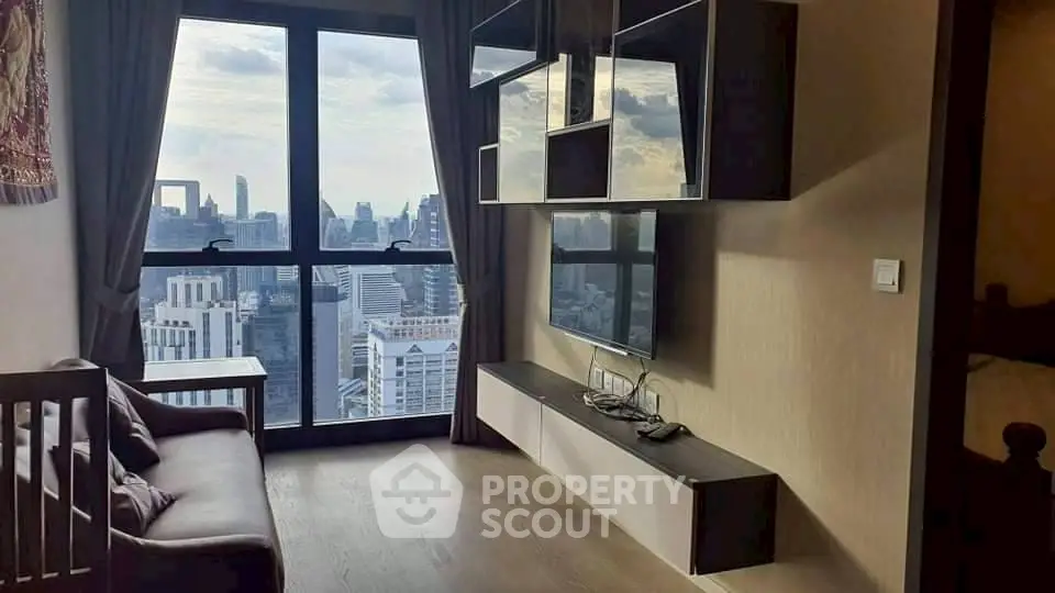 Modern living room with stunning city view from high-rise apartment window.