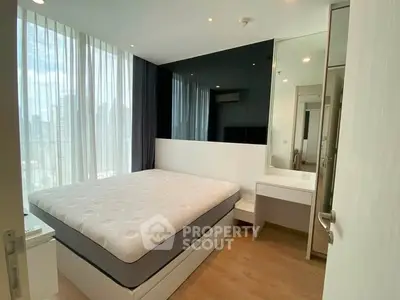 Modern bedroom with large windows and city view, featuring a comfortable bed and sleek design.