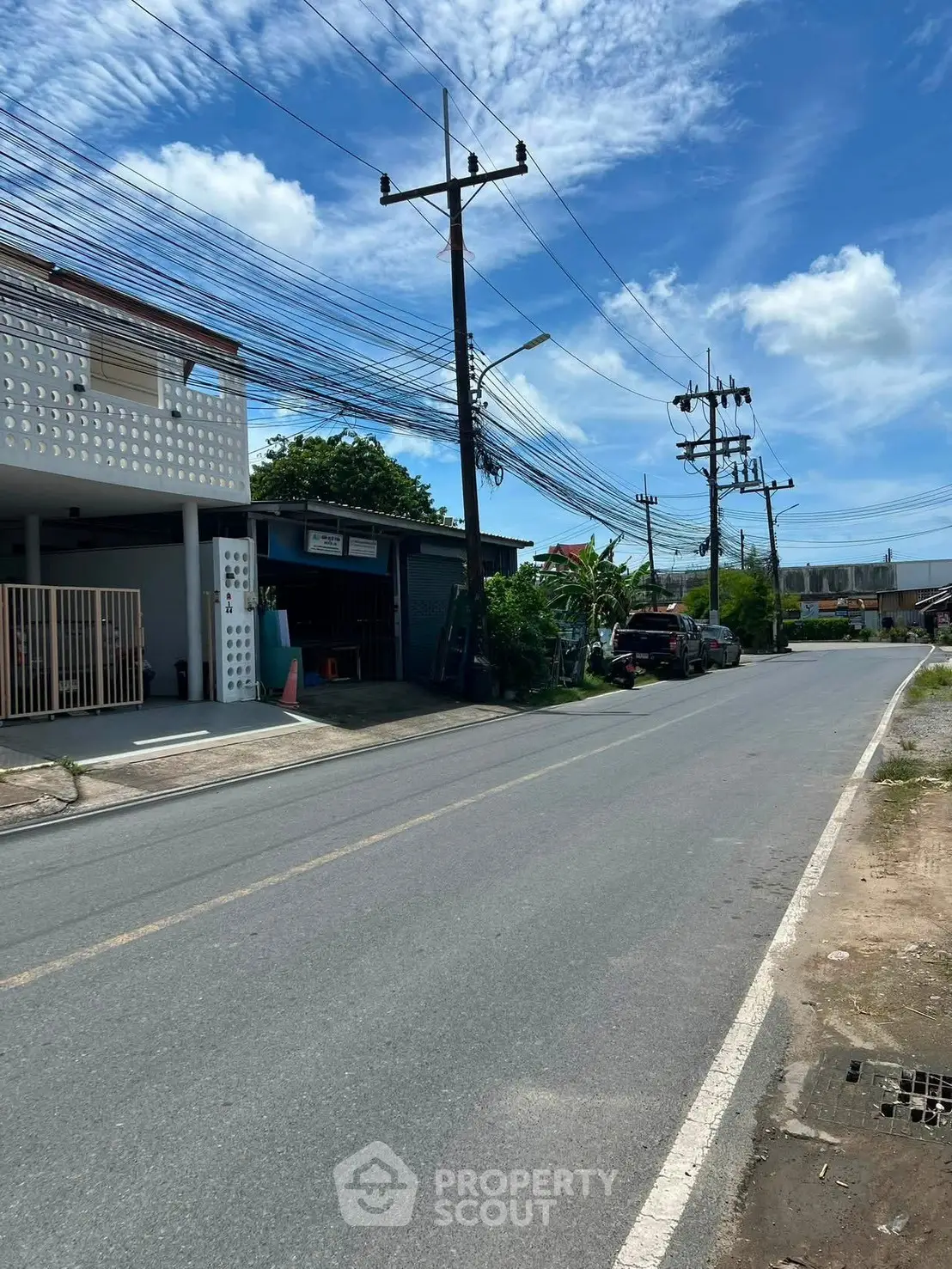Charming suburban street view with clear skies and residential buildings, ideal for peaceful living.