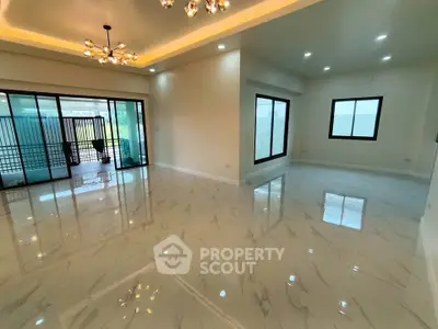 Spacious modern living room with elegant lighting and marble flooring