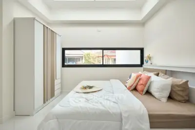 Bright and cozy bedroom with modern decor and large window