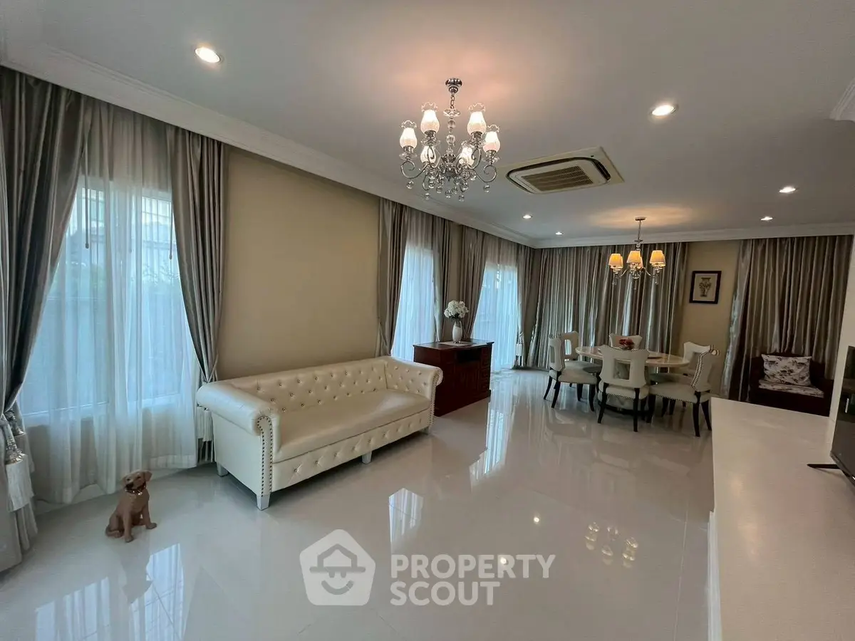 Elegant living and dining area with chandelier and luxurious furnishings