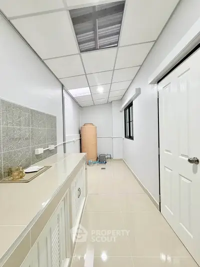 Sleek modern kitchen with glossy tiles and ample storage space