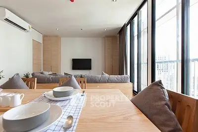 Spacious modern living room with large windows and stylish decor