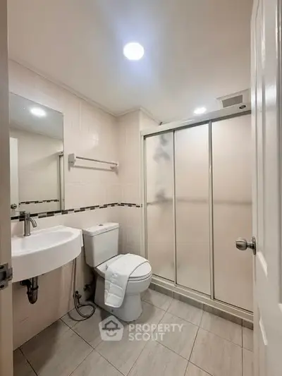 Modern bathroom with sleek fixtures and spacious shower area.