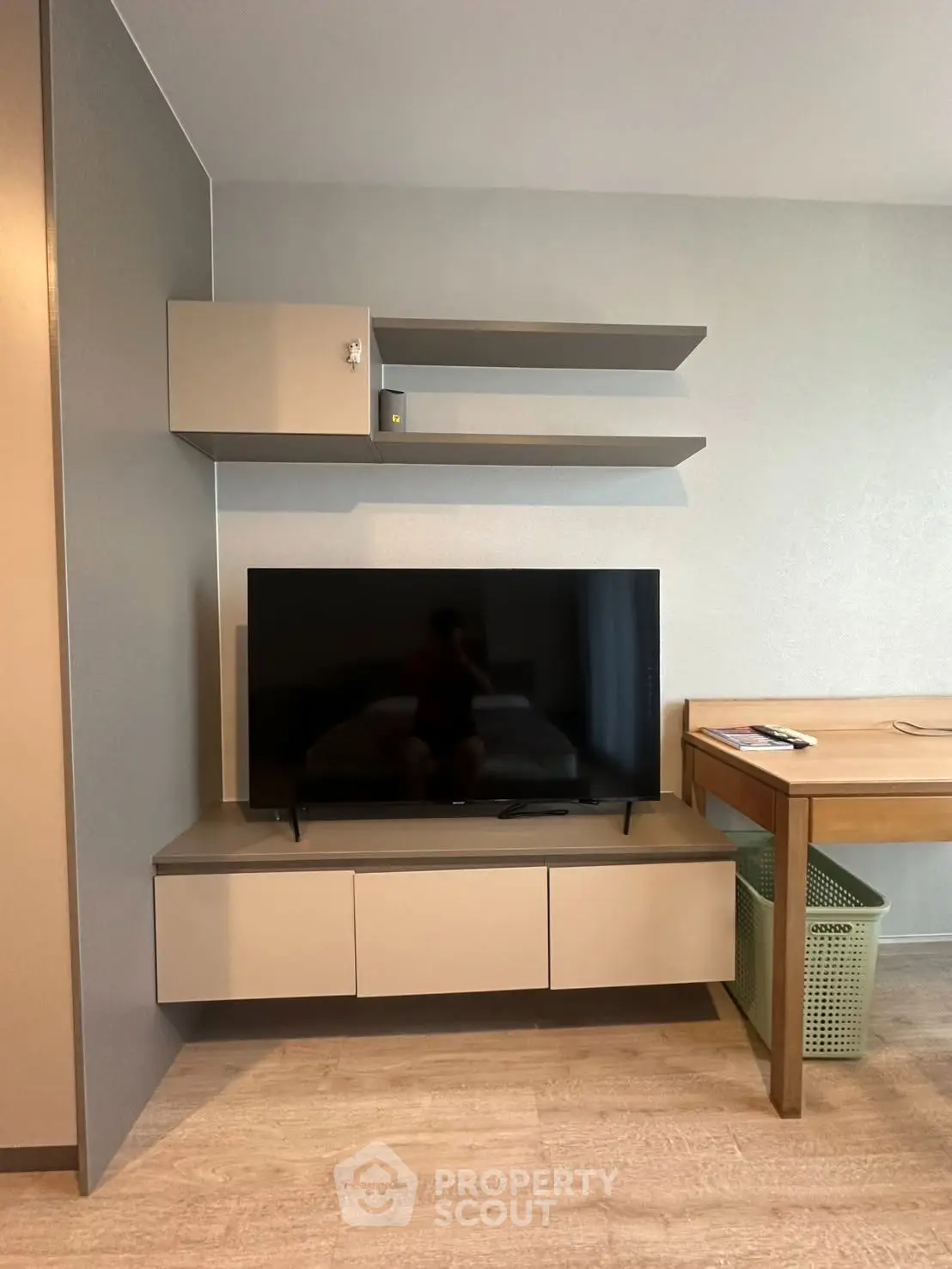 Modern living room with sleek TV stand and floating shelves, perfect for contemporary living spaces.