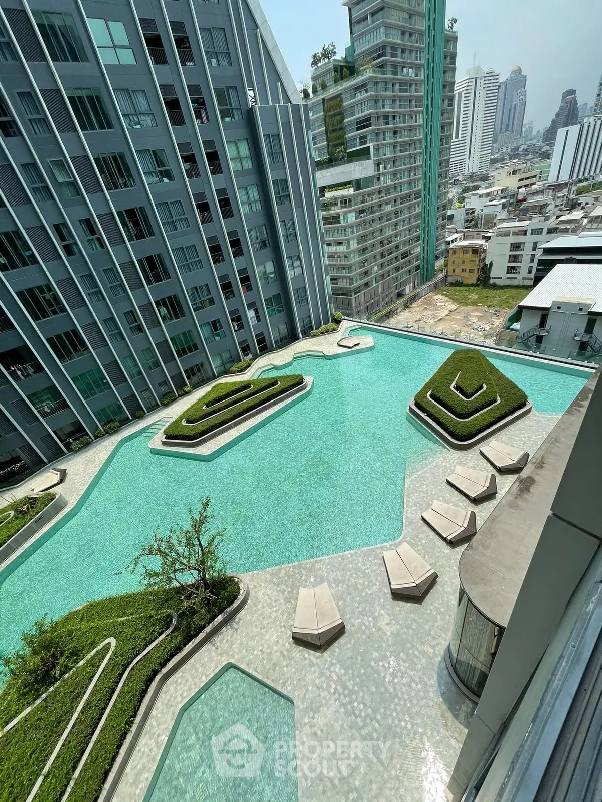 Luxurious high-rise building with stunning rooftop pool and city views, perfect for urban living.