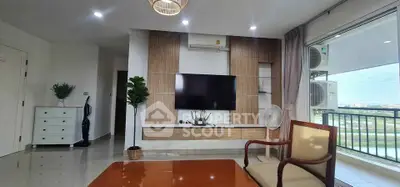 Modern living room with large TV and balcony view in stylish apartment