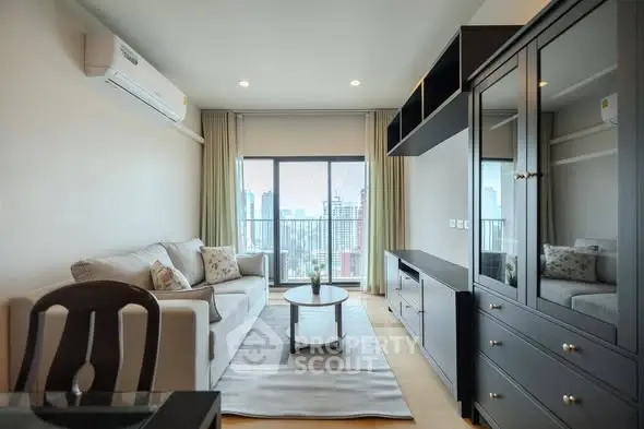 Modern living room with city view, featuring sleek furniture and large windows for natural light.