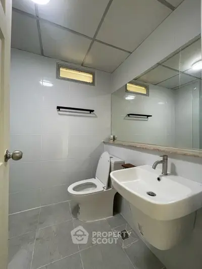 Modern bathroom with sleek fixtures and minimalist design.