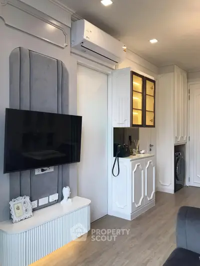 Modern living room with sleek TV setup and stylish cabinetry