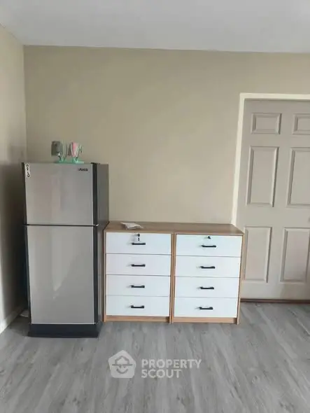 Modern kitchen with sleek fridge and ample storage space