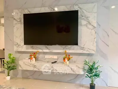 Luxurious living room with marble TV wall and elegant decor