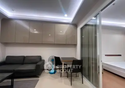 Modern living room with sleek furniture and open layout in a stylish apartment.
