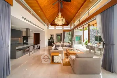 Luxurious open-plan living room with high ceilings and elegant chandelier in modern villa.