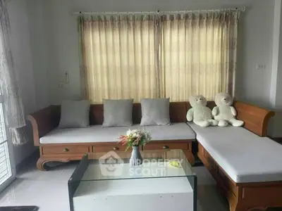 Cozy living room with wooden furniture and plush teddy bears, perfect for relaxation.