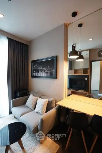 Modern living room with cozy seating and stylish decor in a contemporary apartment.